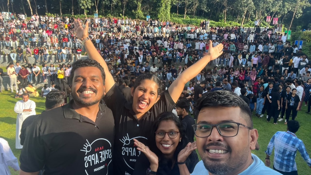 Mentors and organizers taking a selfie in front of the amphitheater crowd