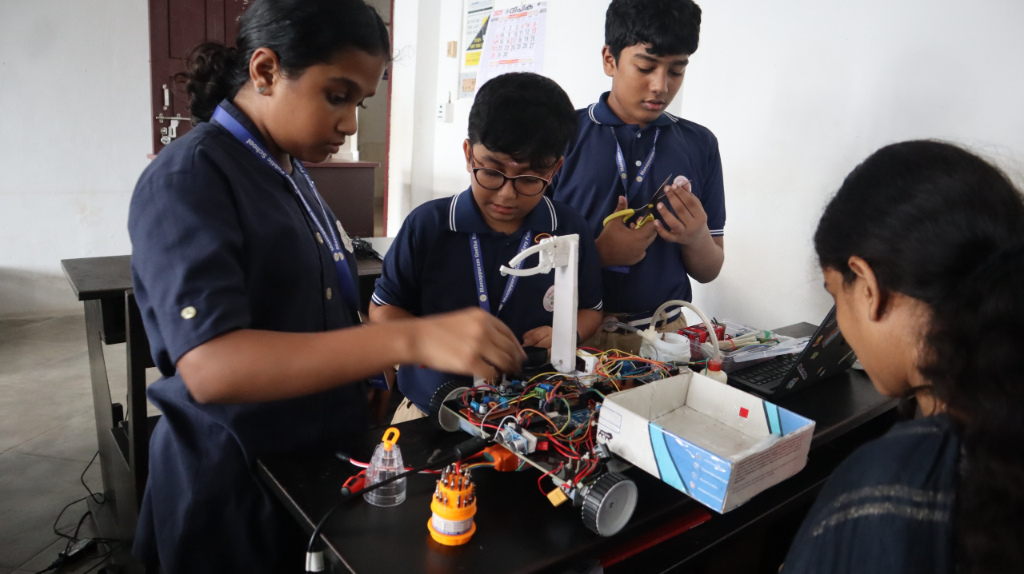 Young students building and testing a robotics rover